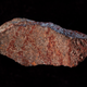 The red marks on this flake represent the oldest known drawing in the archaeological record, according to new research.